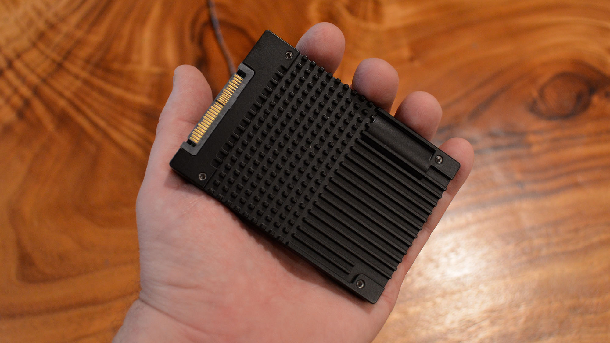 A FlumeIO F5900-series SSD in a masculine hand