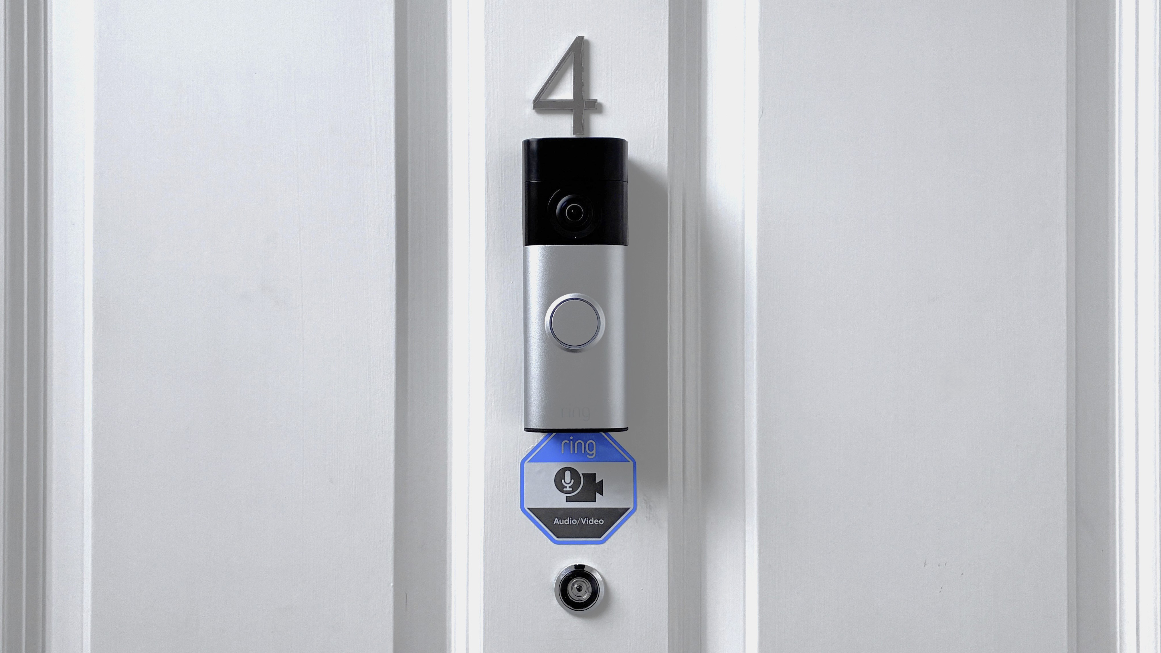 Ring Battery Video Doorbell Plus (2nd Gen) mounted above peephome on front door