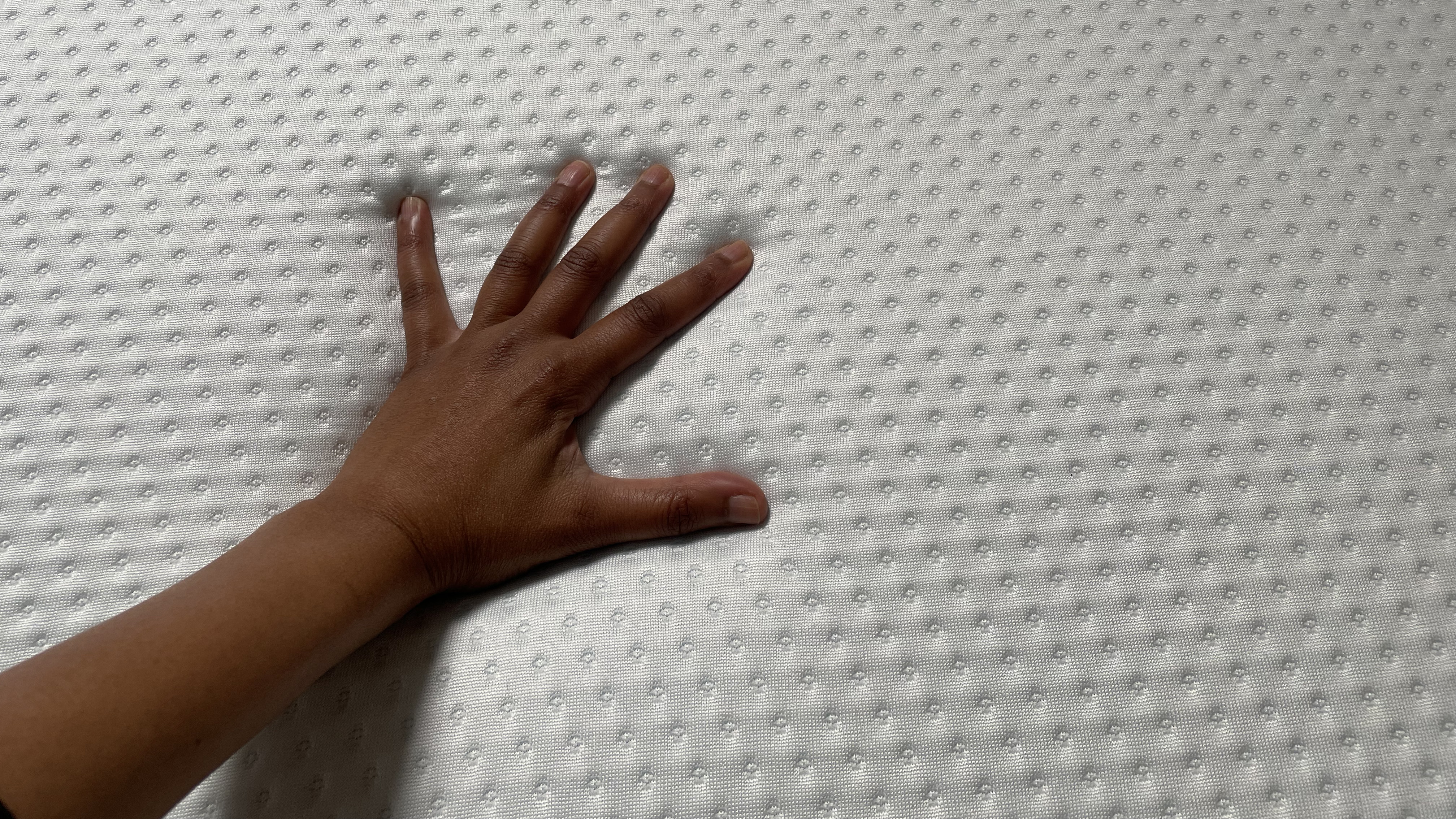 Emma Mattress with tester's hand resting on it