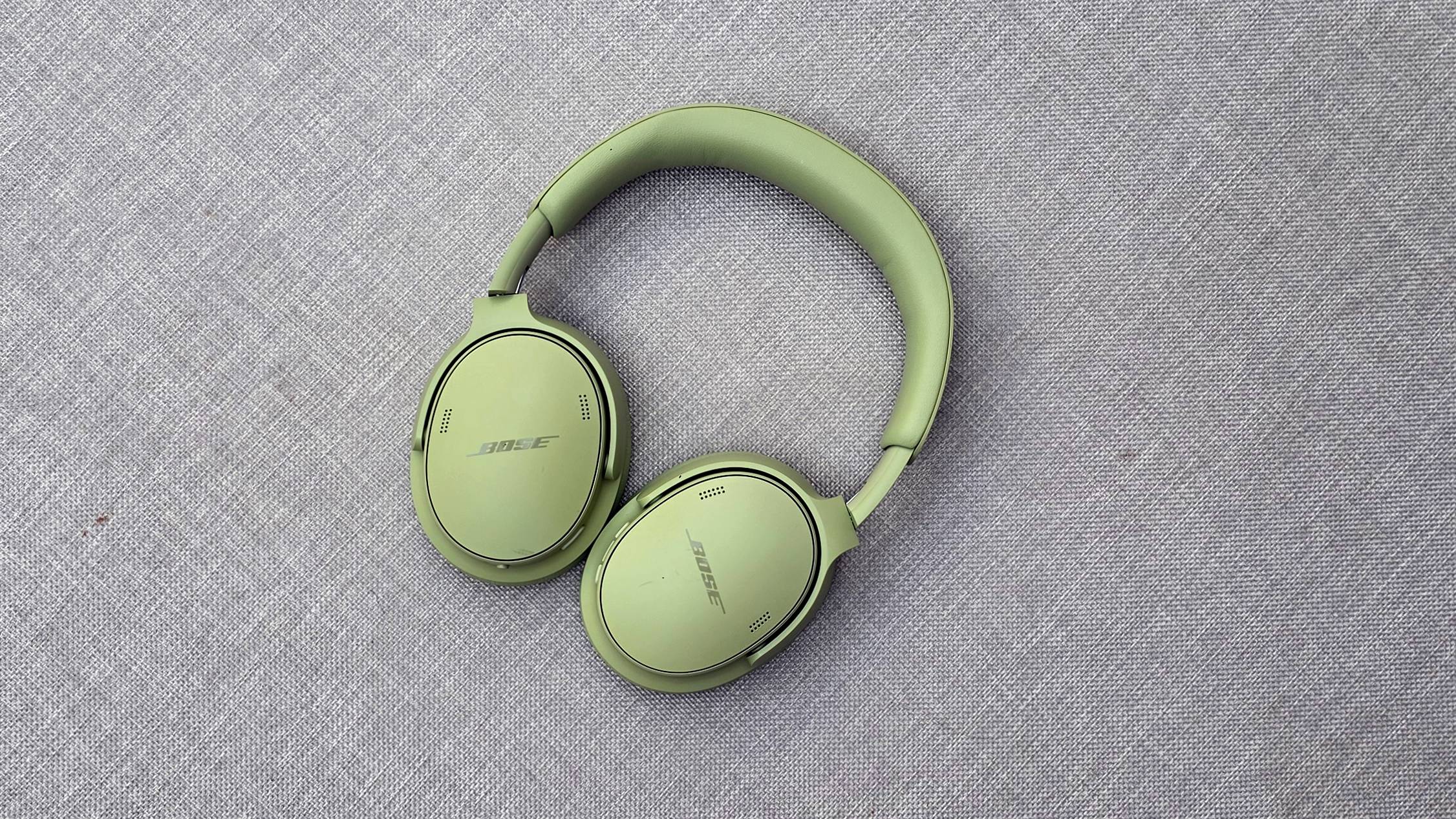 The Bose QuietComfort Headphones (2nd Gen) flat down on a gray fabric.