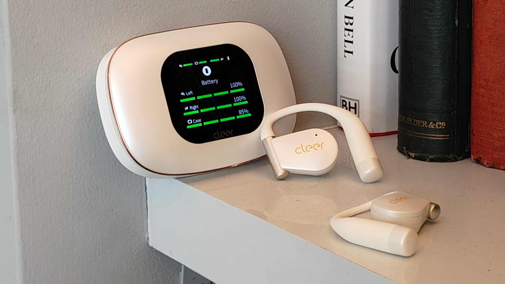 The Cleer Arc 5 buds in a shelf, next to the case.
