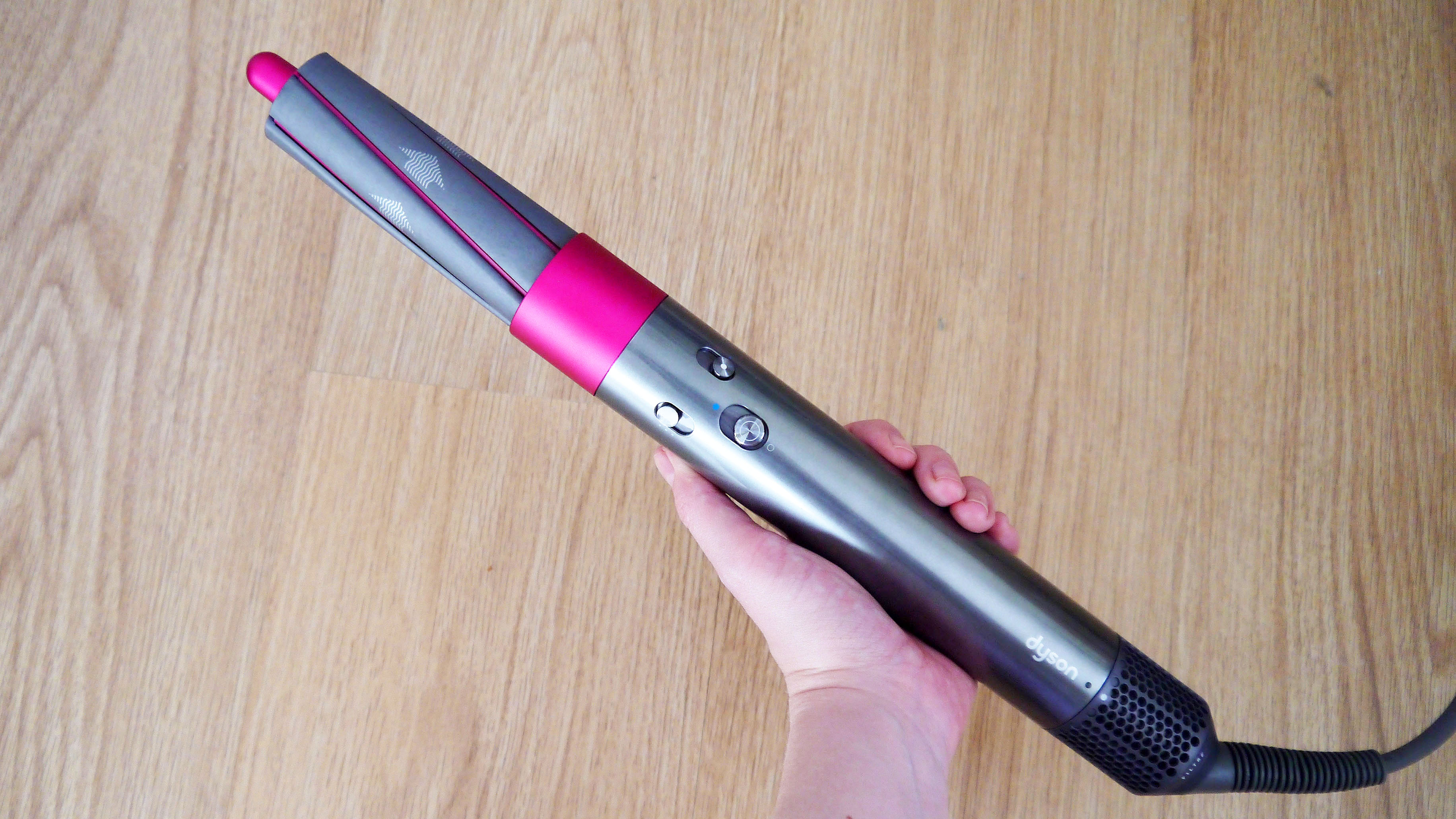 Dyson airwrap held in hand to show the buttons