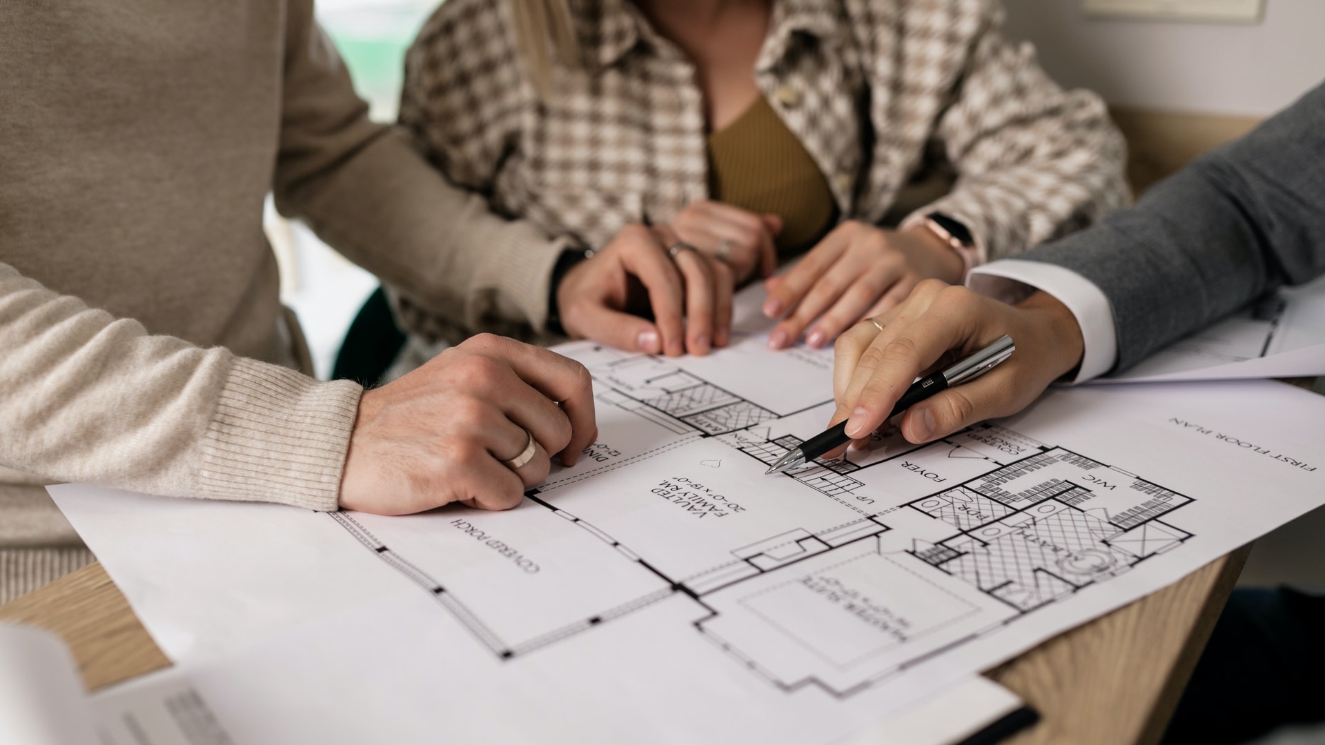 people looking over architects' plans