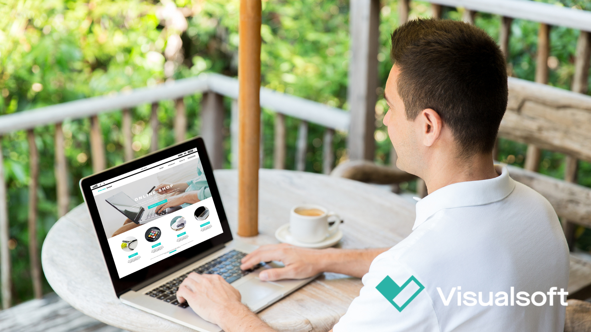 Man looking at a browser on his laptop displaying the VisualSoft website