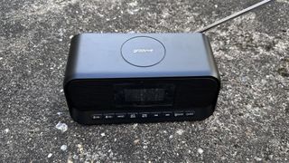 The Groov-E-Zeus DAB FM radio clock against cement