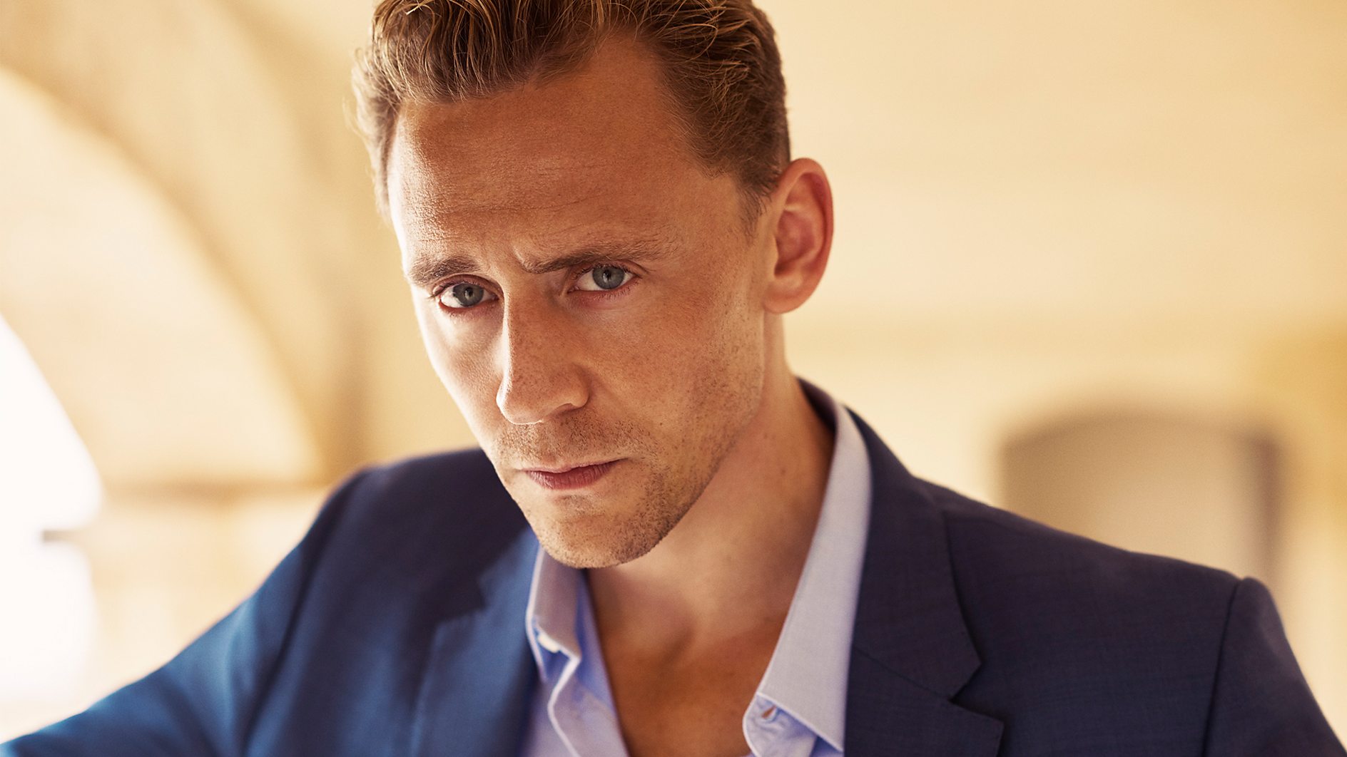 Tom Hiddleston as Jonathan Pine in a suit
