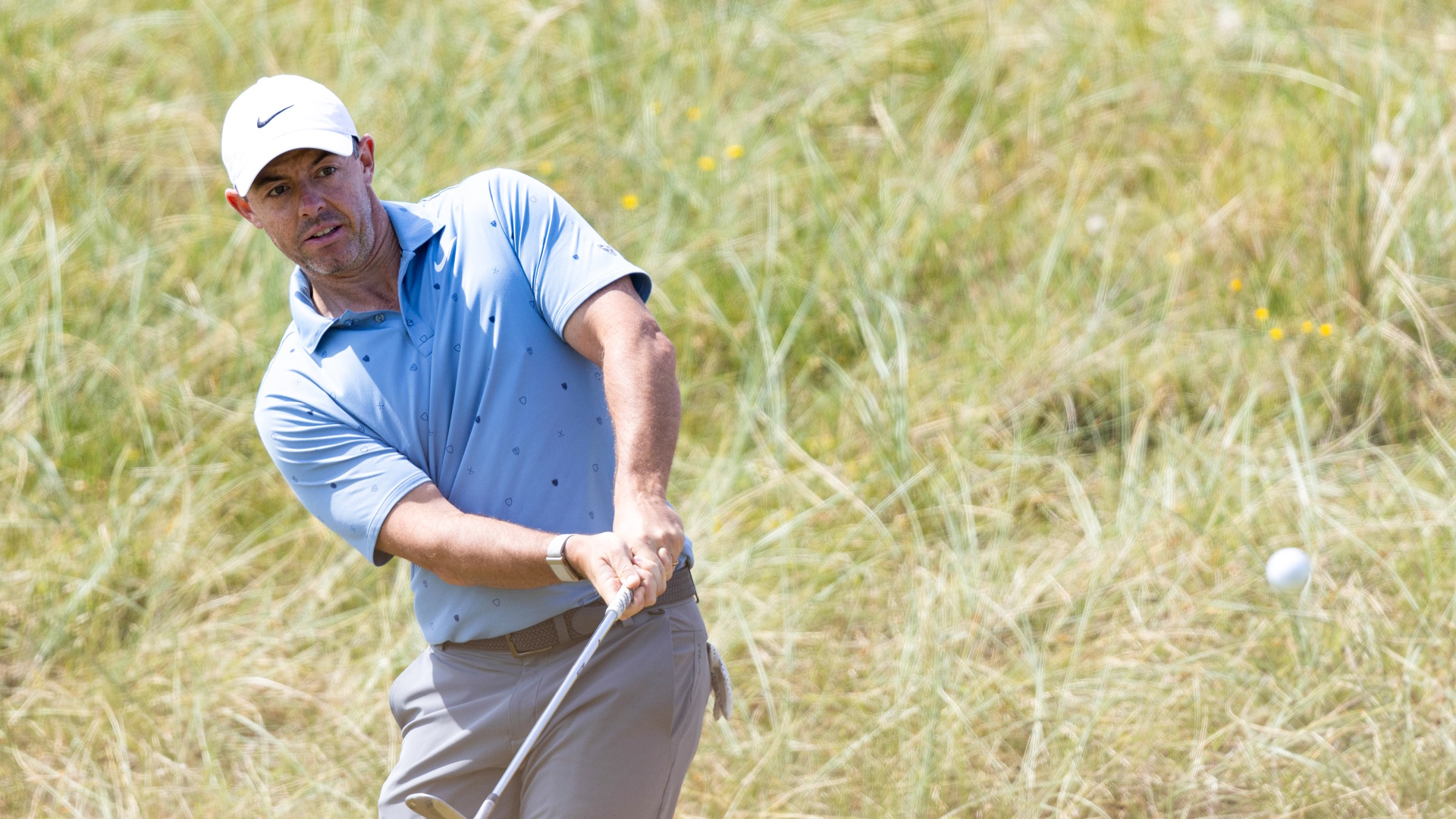 Rory McIlroy of Northern Ireland playing a shot from the rough during the 2026 Genesis Scottish Open at the Renaissance Club.
