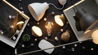 Collection of IKEA lights scattered on black background