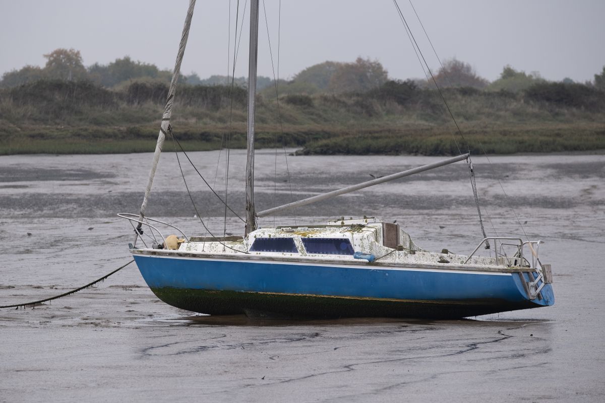 A boat on mud flats at low tide