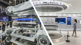 The internals of an electric car showcasing a fast-charging battery, next to a person at a Beijing Auto Show stand for an electric battery