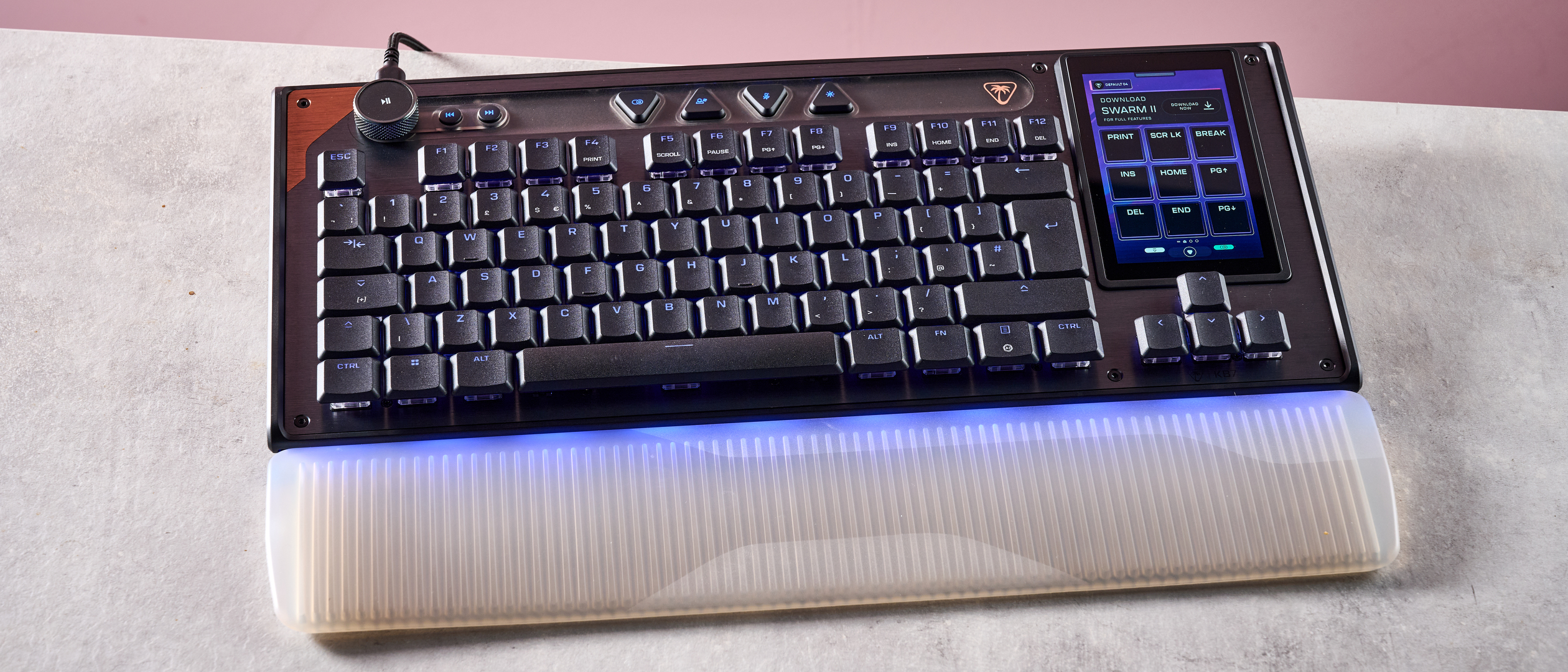 The Turtle Beach Command Series KB7 and wrist rest at a slight angle in front of a pink background.