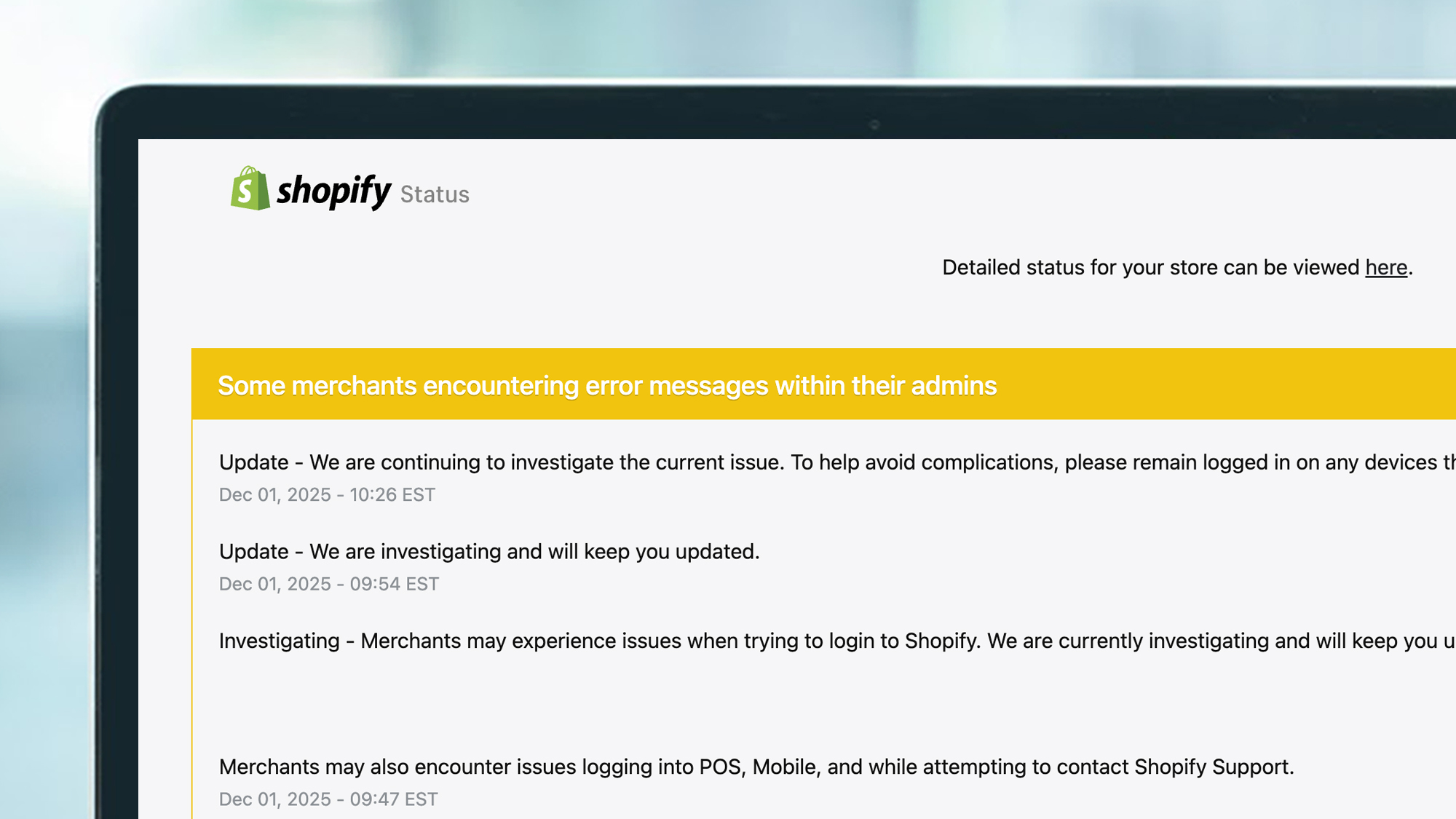 A laptop screen showing a Shopify outage status