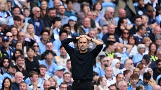 Pep Guardiola holding his hands to his head during a recent Tottenham vs Man City game