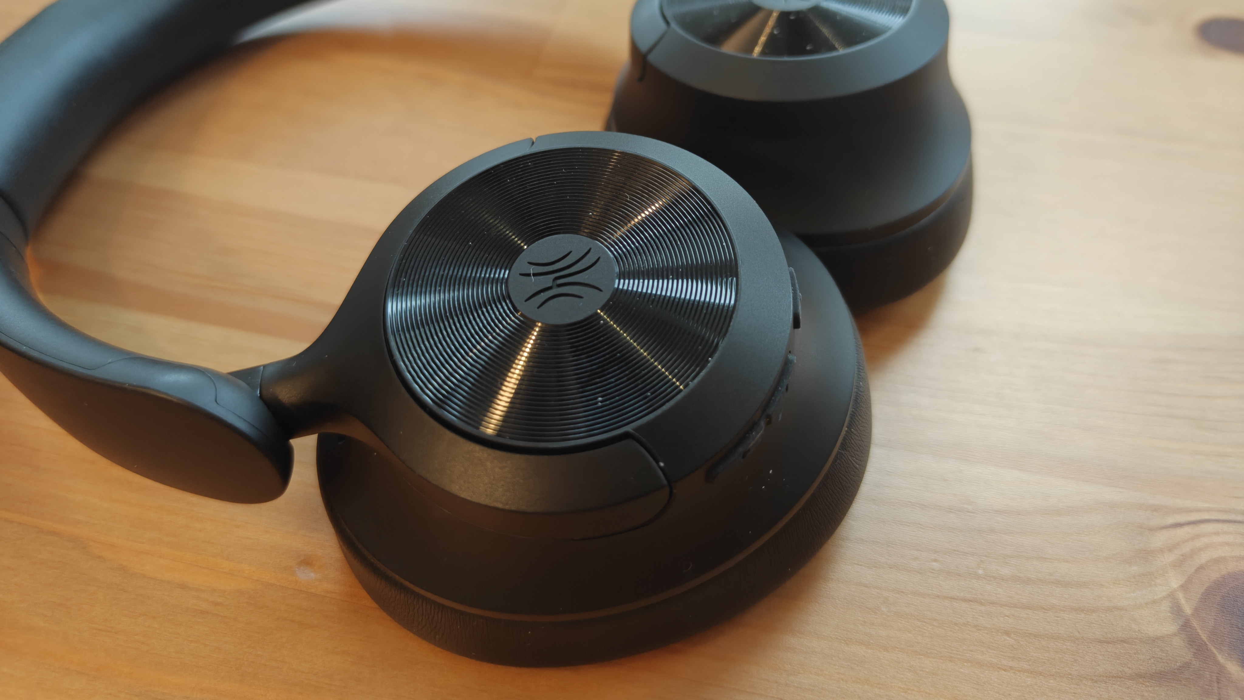 The OneOdio Focus A1 Pro on a wooden table.