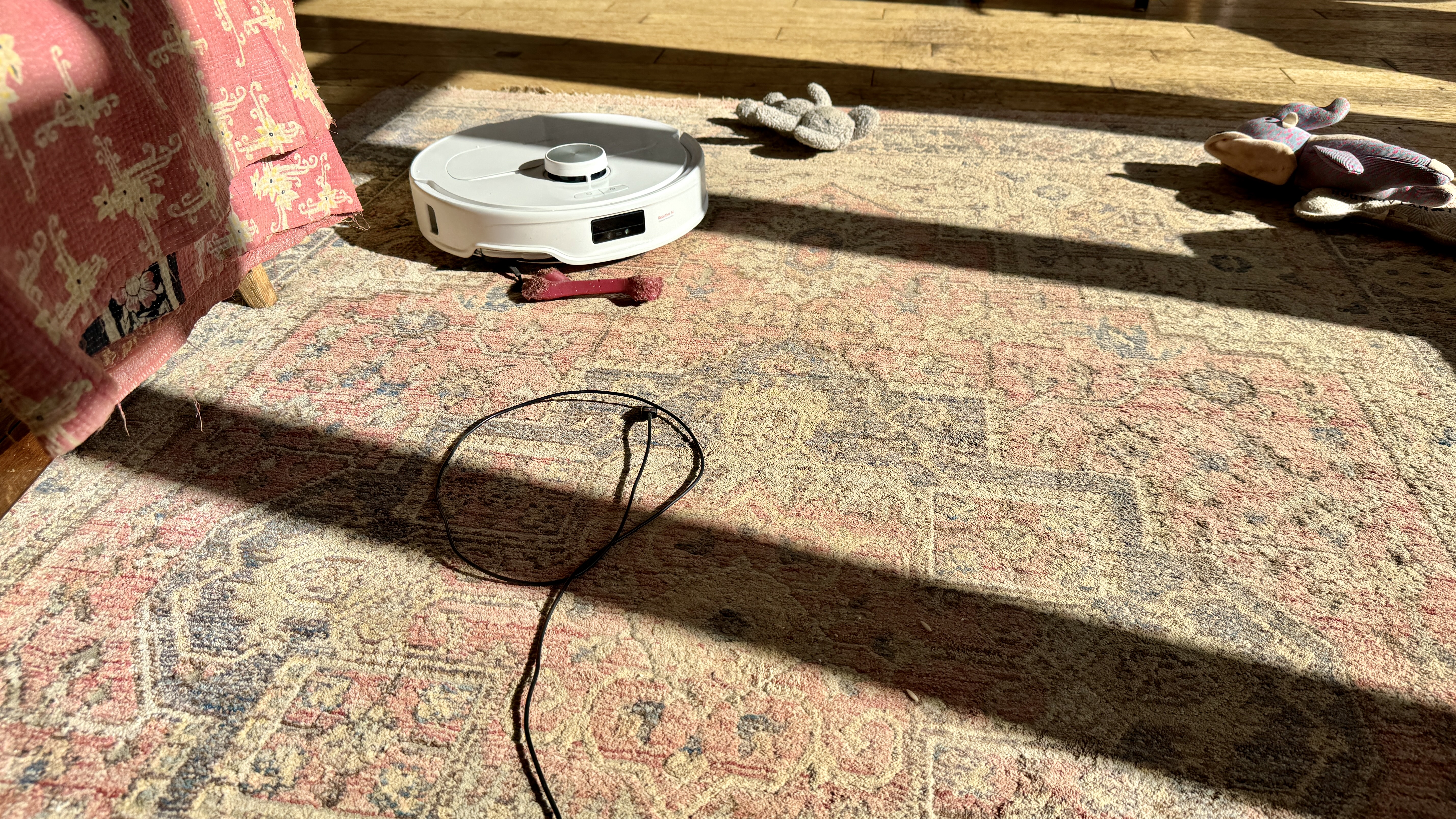Roborock Qrevo Master robot vacuum surrounded by obstacles during object avoidance tests