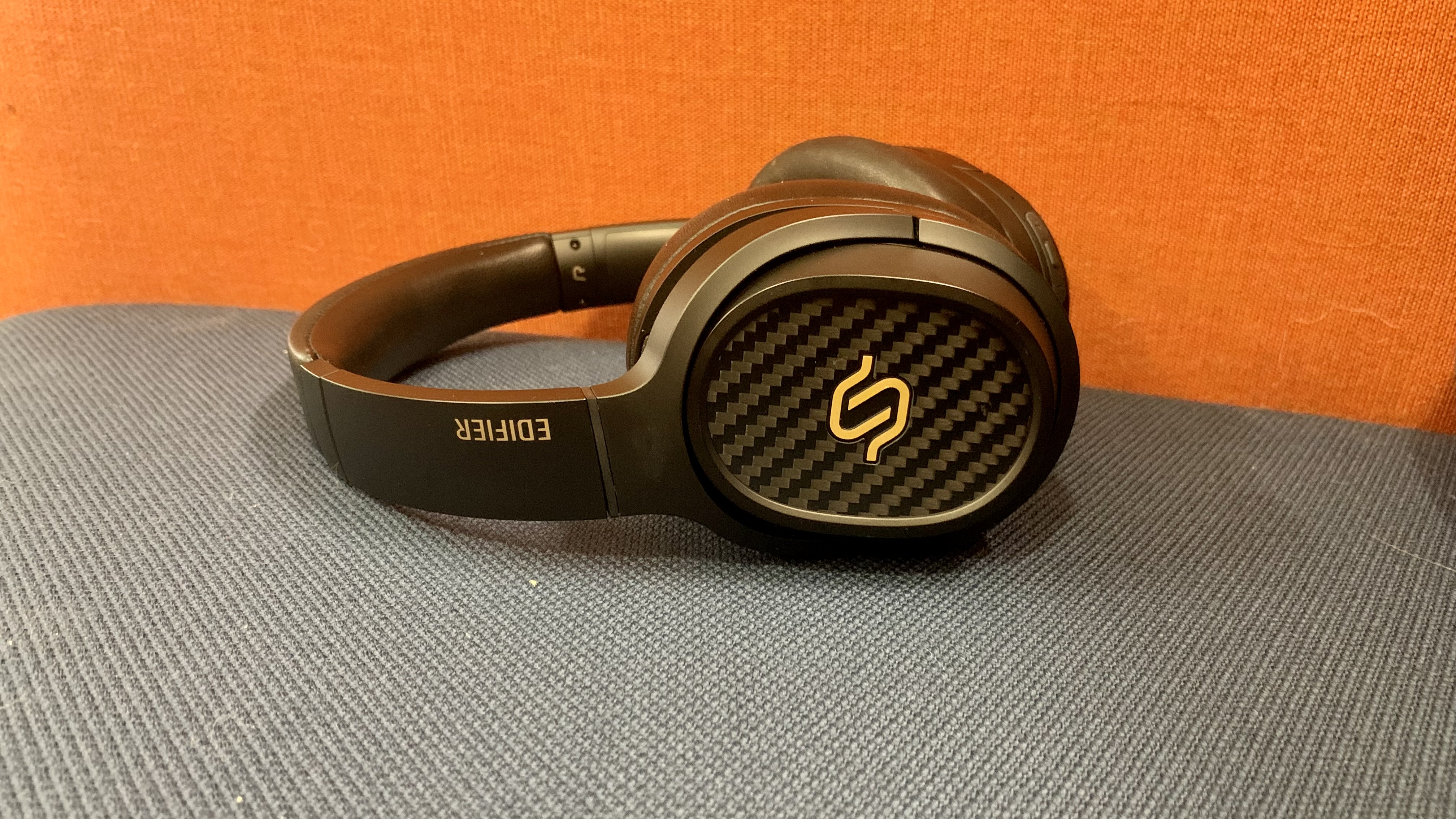 Edifier Stax Spirit S3 on orange/gray sofa