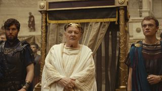 Emperor Vespasian is flanked by two guards in Amazon's Those About To Die TV series