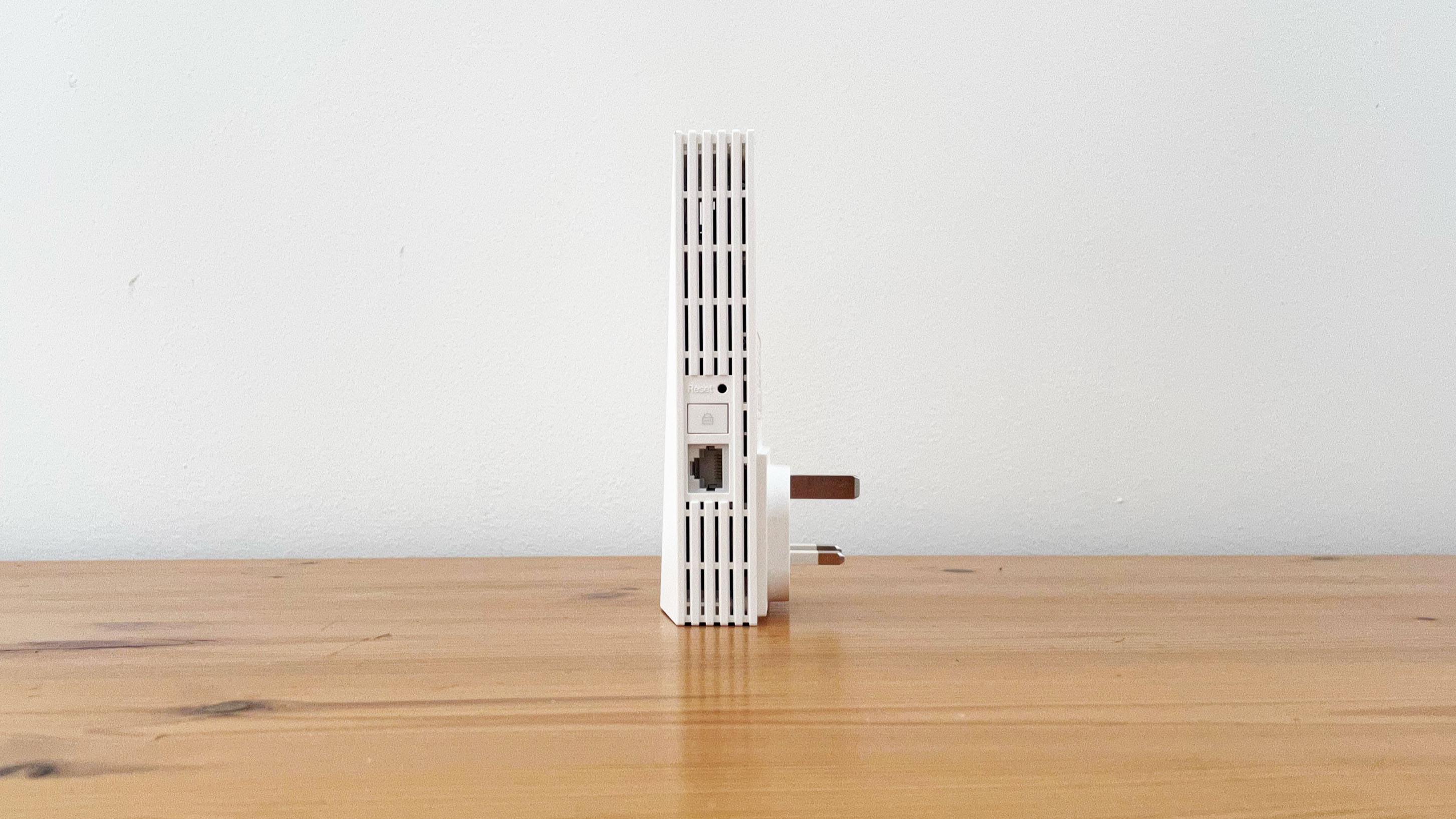 TP-Link RE700X on a wooden desk