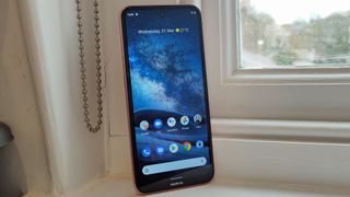 A Nokia X20 from the front, standing on a window sill