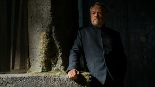 Hari Seldon leaning on a wall in Foundation season 3