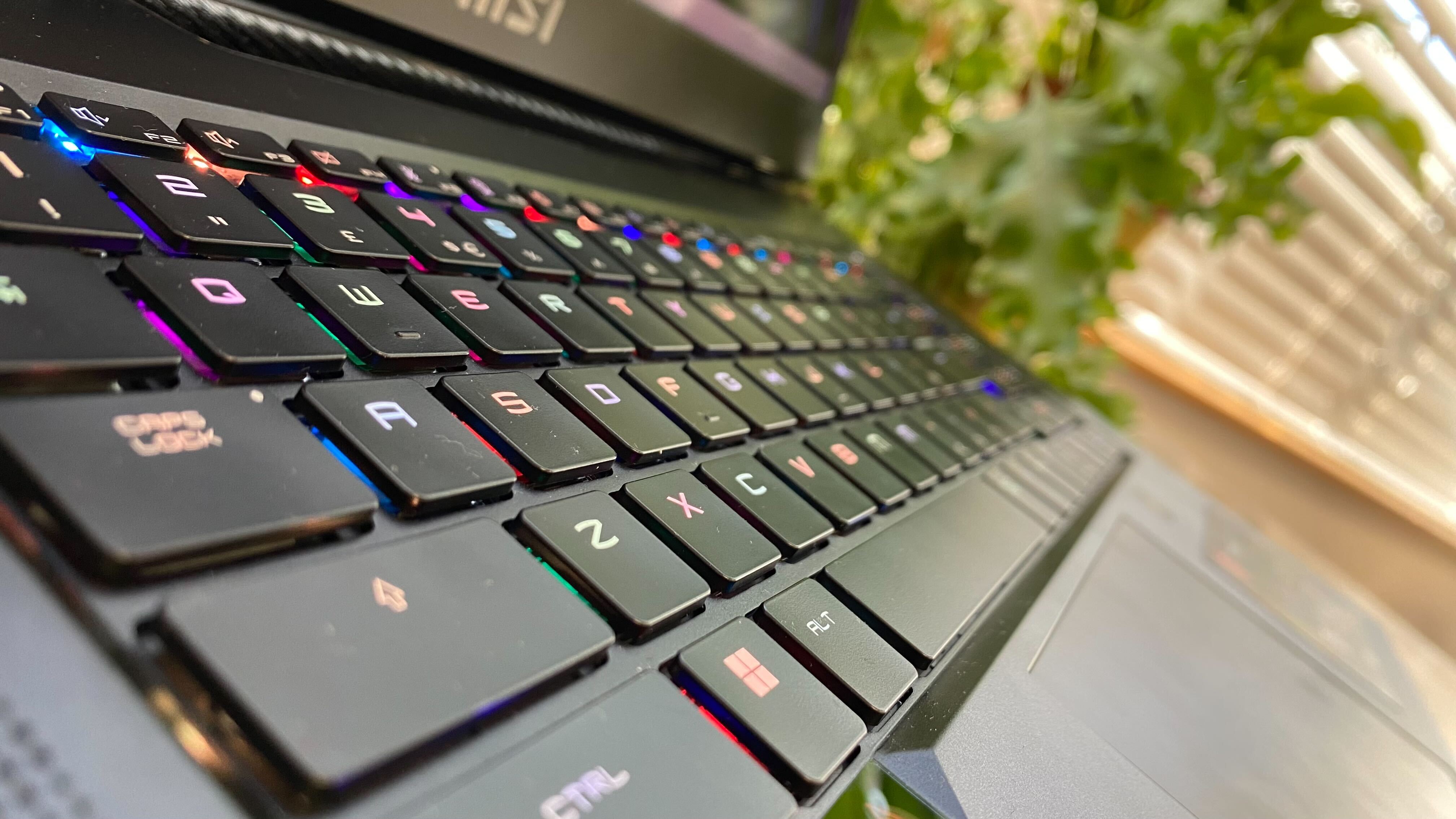 Photos of MSI GT77 on a wooden table at various angles