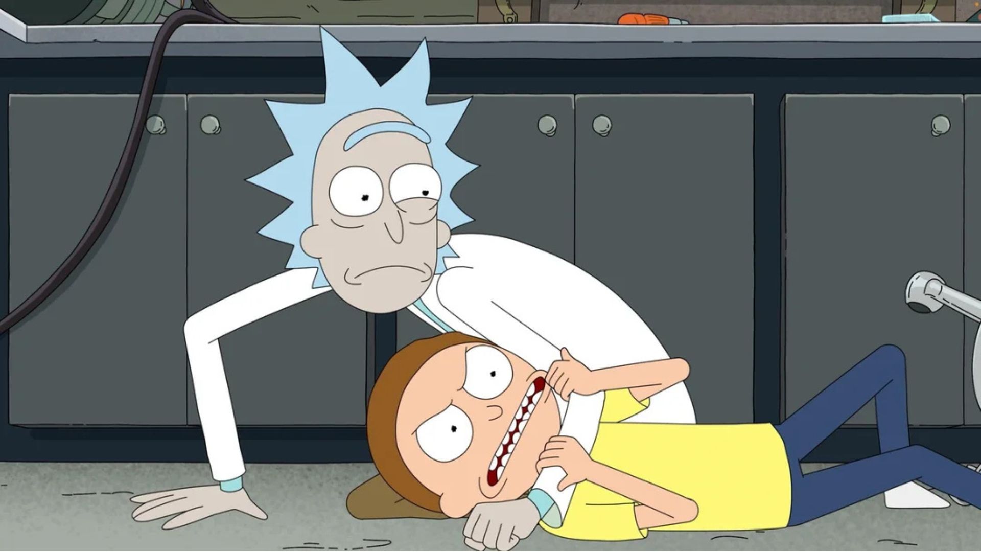 Rick has Morty on the floor in a headlock