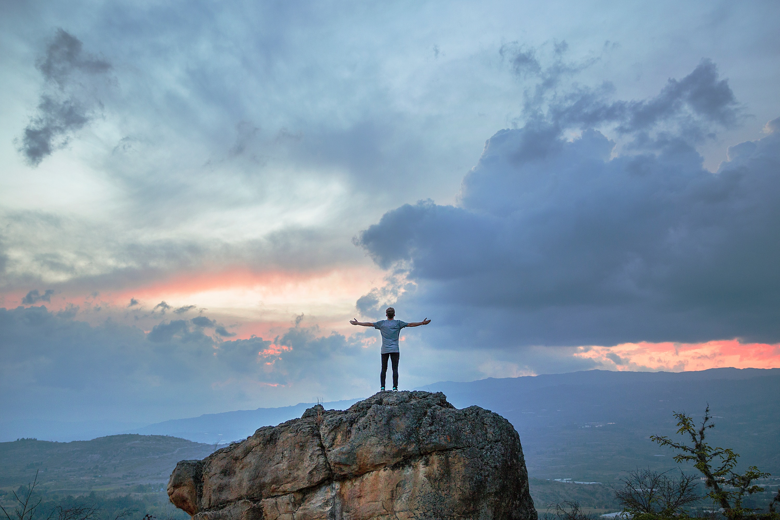person on top of a mountain celebrating an achievement