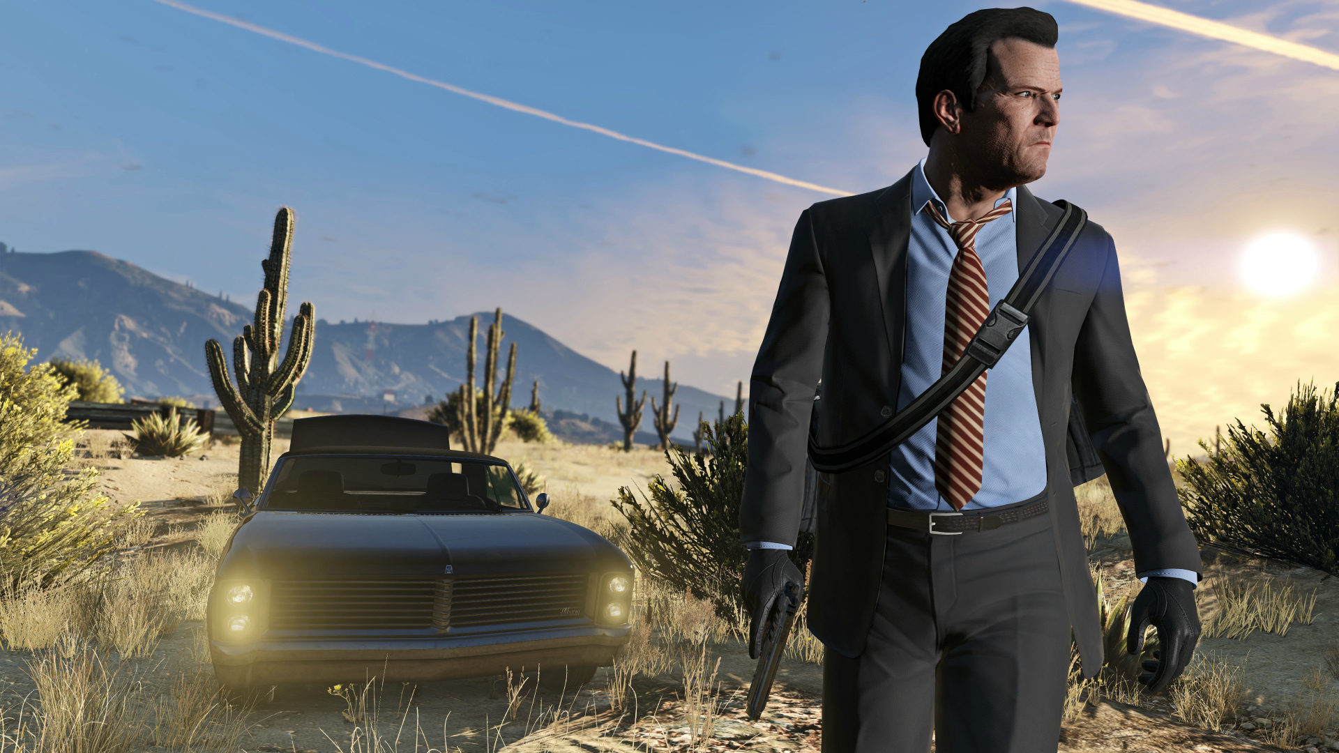 Michael from GTA 5 wearing a grey suit and walking outside in the desert with a car behind him.
