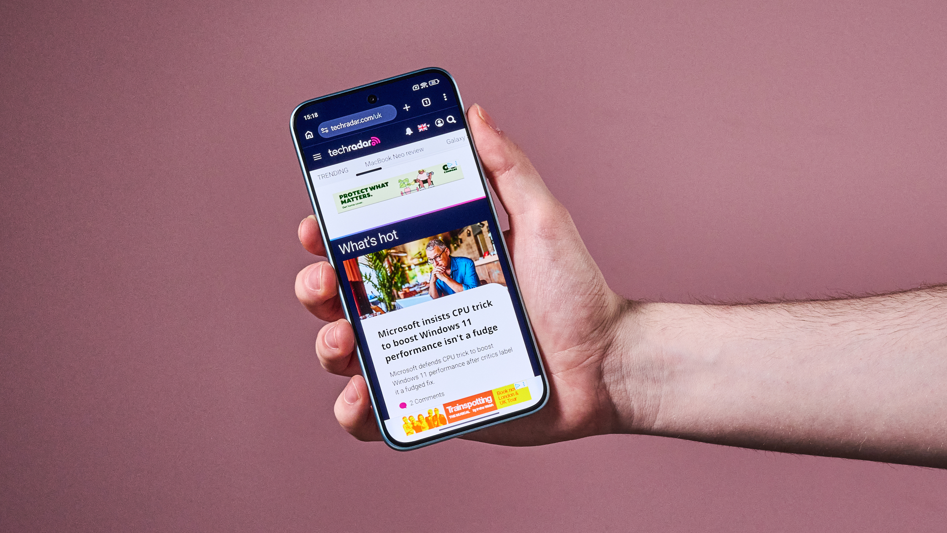 Man holding the Xiaomi Redmi Note 15 Pro 5G with TechRadar website shown on the display