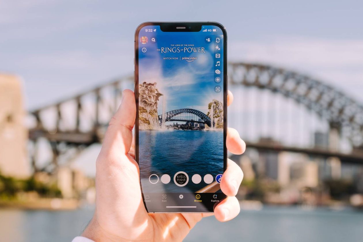 A Snapchat AR filter showing set pieces from LOTR series 'Rings of Power' emerging from Sydney Harbour