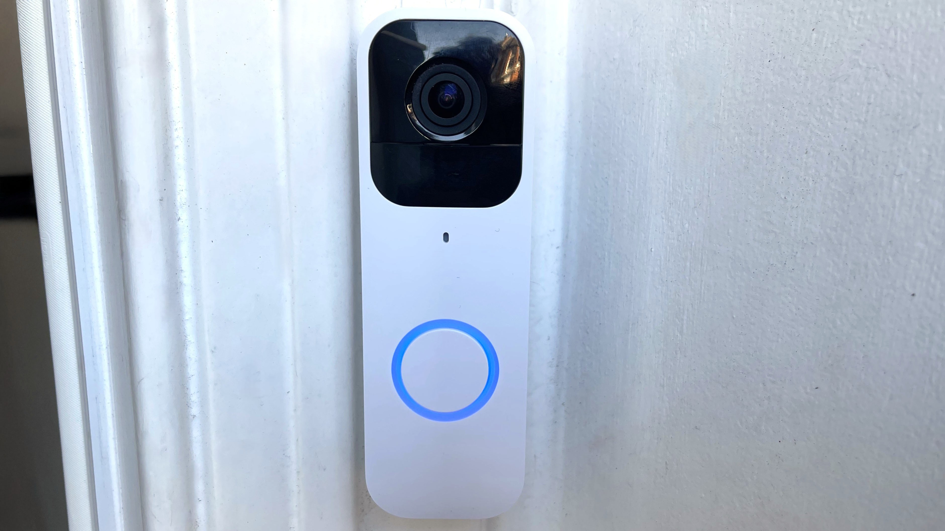 Blink Video Doorbell attached to angled mounting plate with button illuminated