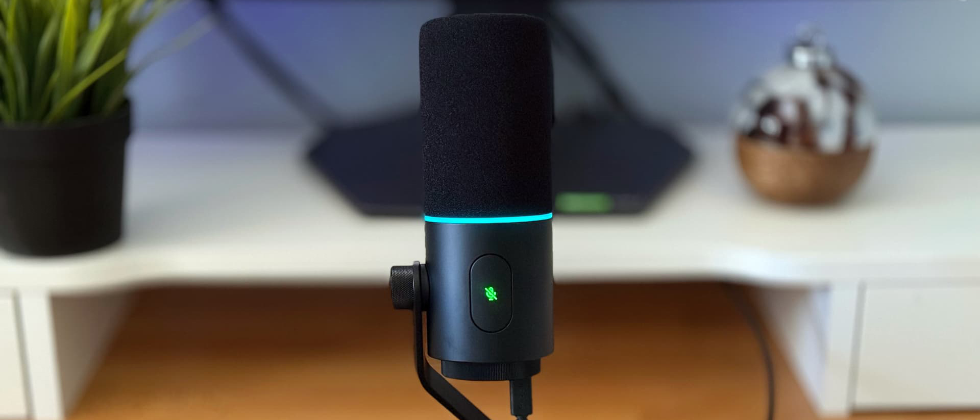 Razer Seiren V3 Pro microphone on wooden desk