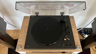 Sony PS-LX510BT turntable on a brown wood hi-fi rack, with closeups