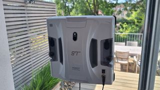 Hobot S7 Pro window cleaning robot on inside of reviewer's patio door window