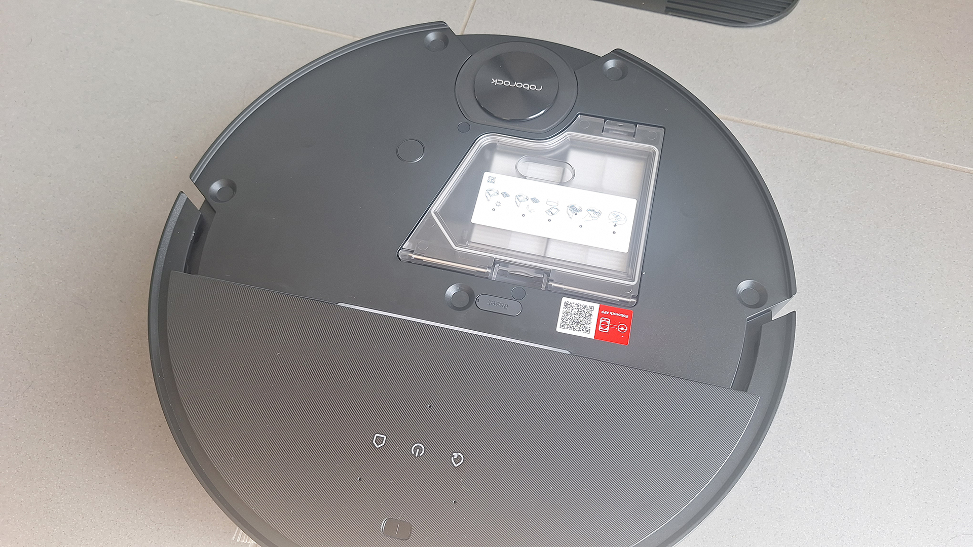 Roborock Saros 10 robot vacuum with top plate removed to show onboard dustbin