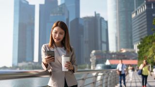 Young woman using mobile phone in Singapore