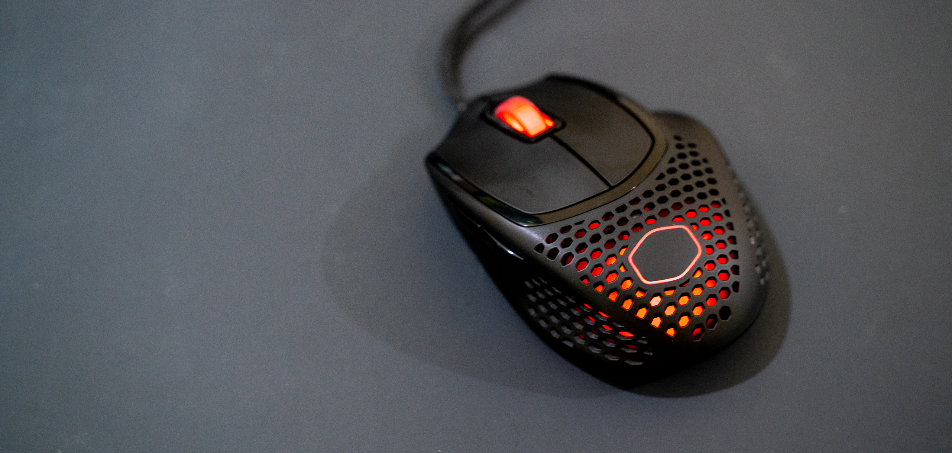 Cooler Master MM720 showcasing its RGB lighting on a computer desk