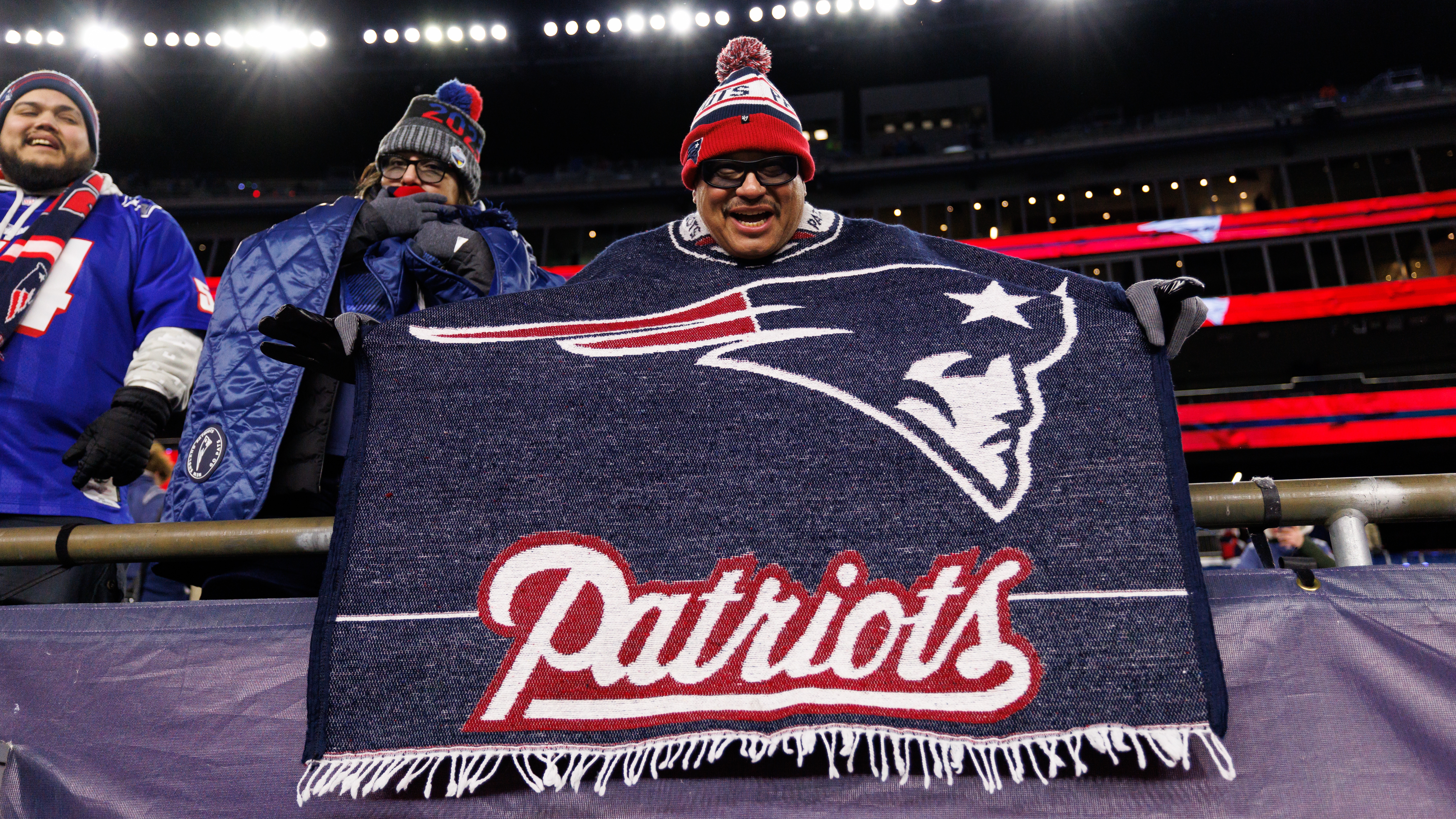 A New England Patriots fan cheers from the stands after an NFL wild card playoff football game against the Los Angeles Chargers at Gillette Stadium on January 11, 2026 in Foxborough, Massachusetts. 