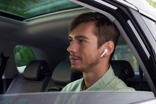 1MORE Aero worn by a man in a car
