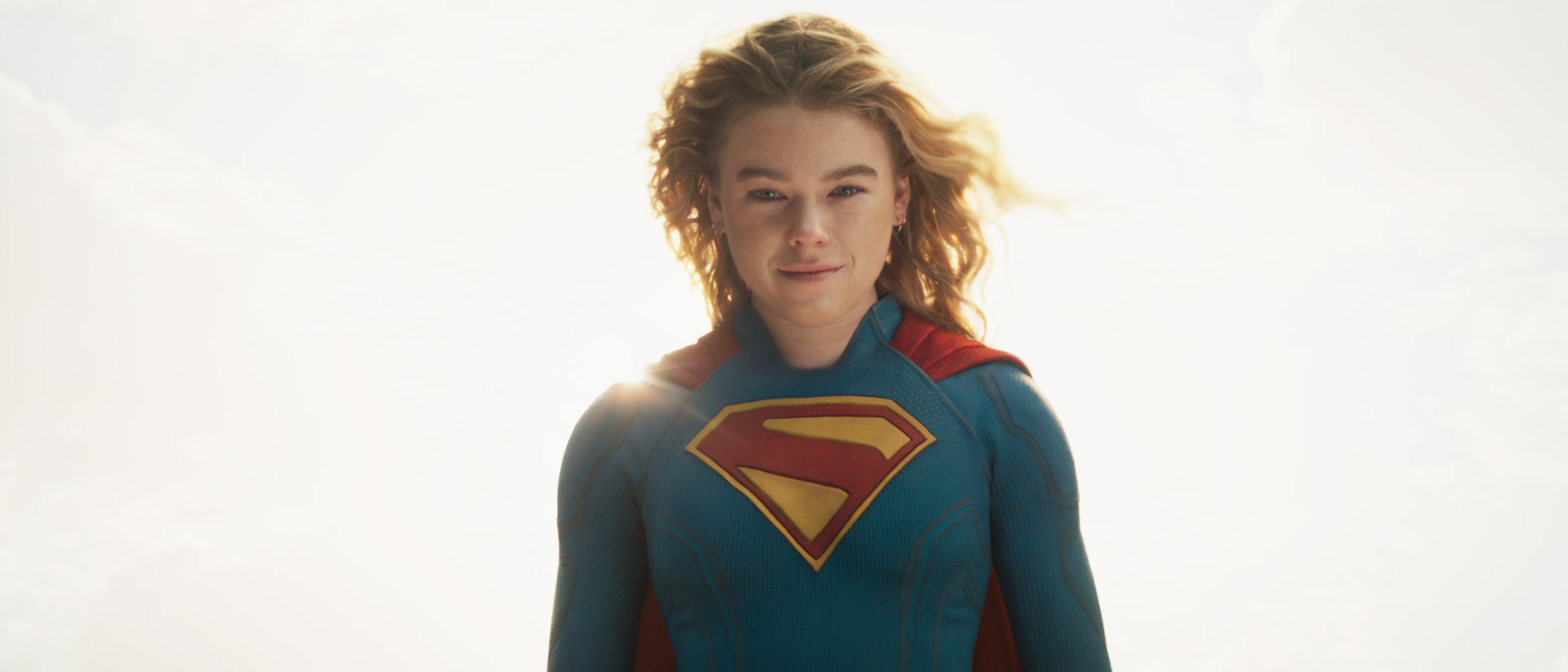 Milly Alcock's Kara Zor-El smiling and looking directly at the camera in 2026's Supergirl movie