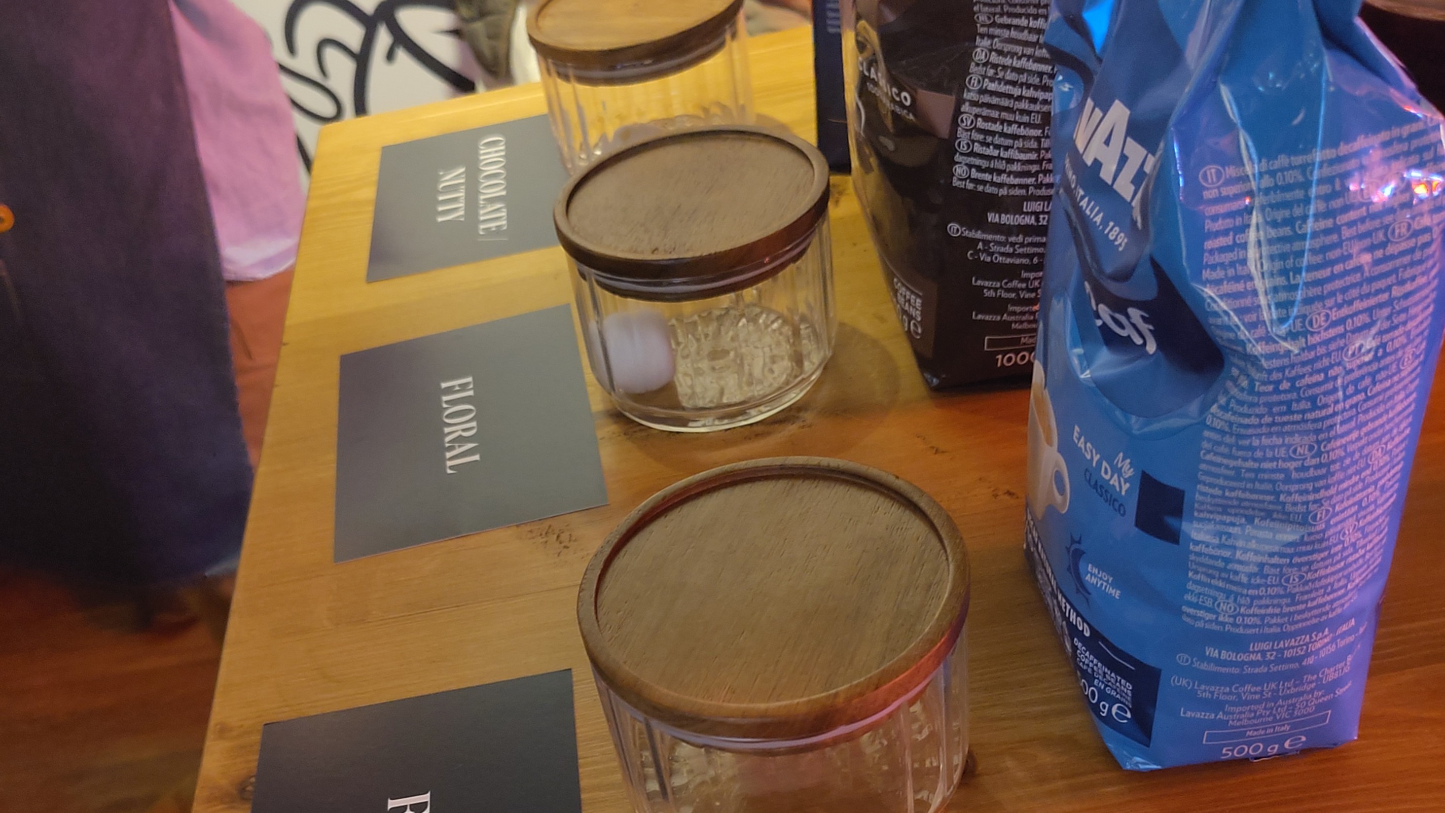 Coffee beans, samples, and tasting notes on table
