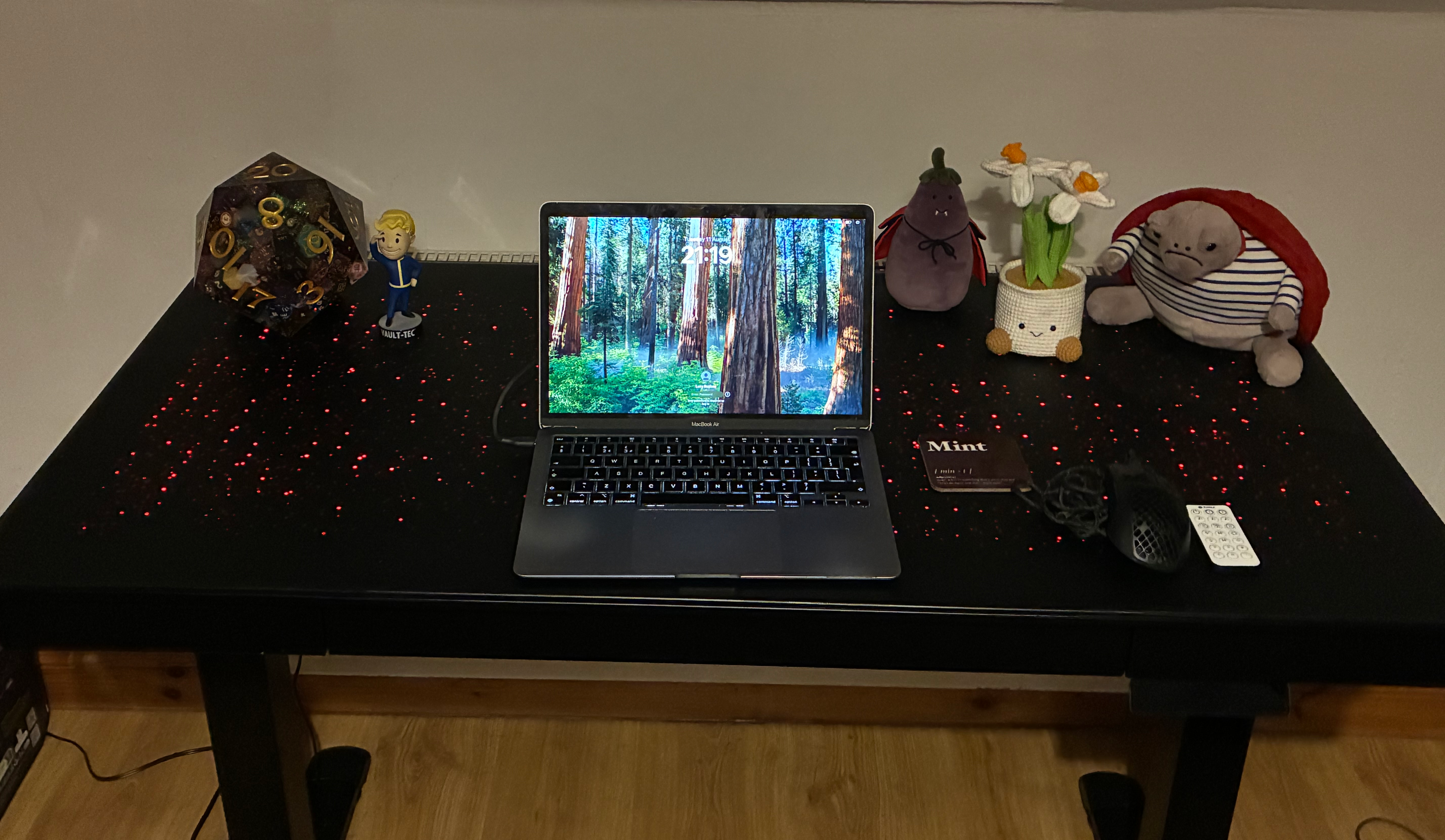 Eureka Ergononomic's Wonder Glowing Desk set up in a slightly darkened room to show the red lights dotted across the top.