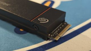 The Seagate FireCuda 530R with heatsink on a colorful fabric desk mat.