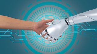 A human shakes a robot's hand in front of blue concentric circles