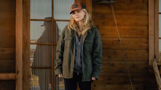 Michelle Pfeiffer looks at something across her cabin porch