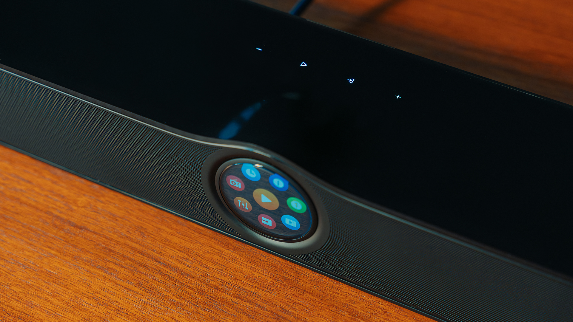 The WiiM Bar's screen in a close-up, also showing touch controls on its top surface