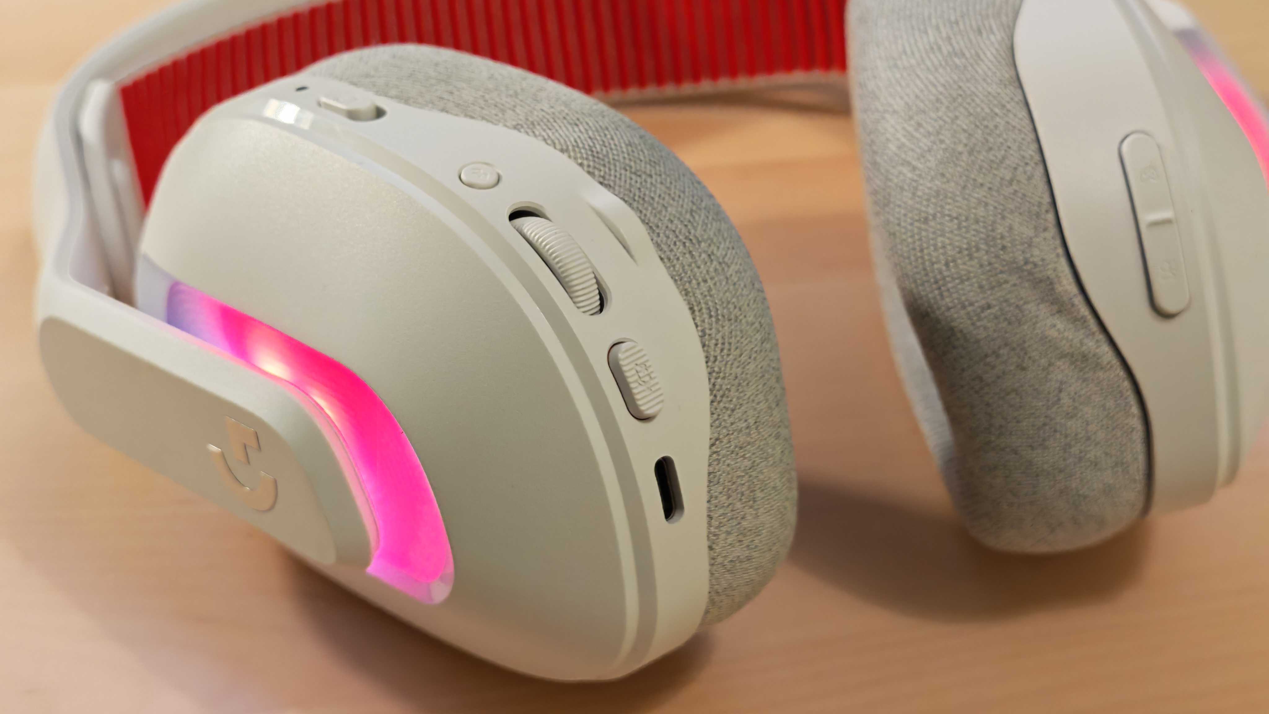 The Astro A20 X gaming headset on a wooden desktop surface.