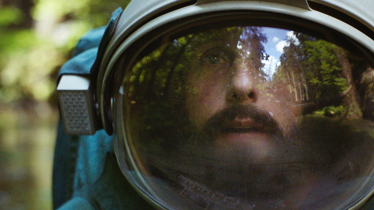 A close up of Adam Sandler's Jakub with his space helmet on in Netflix's Spaceman movie