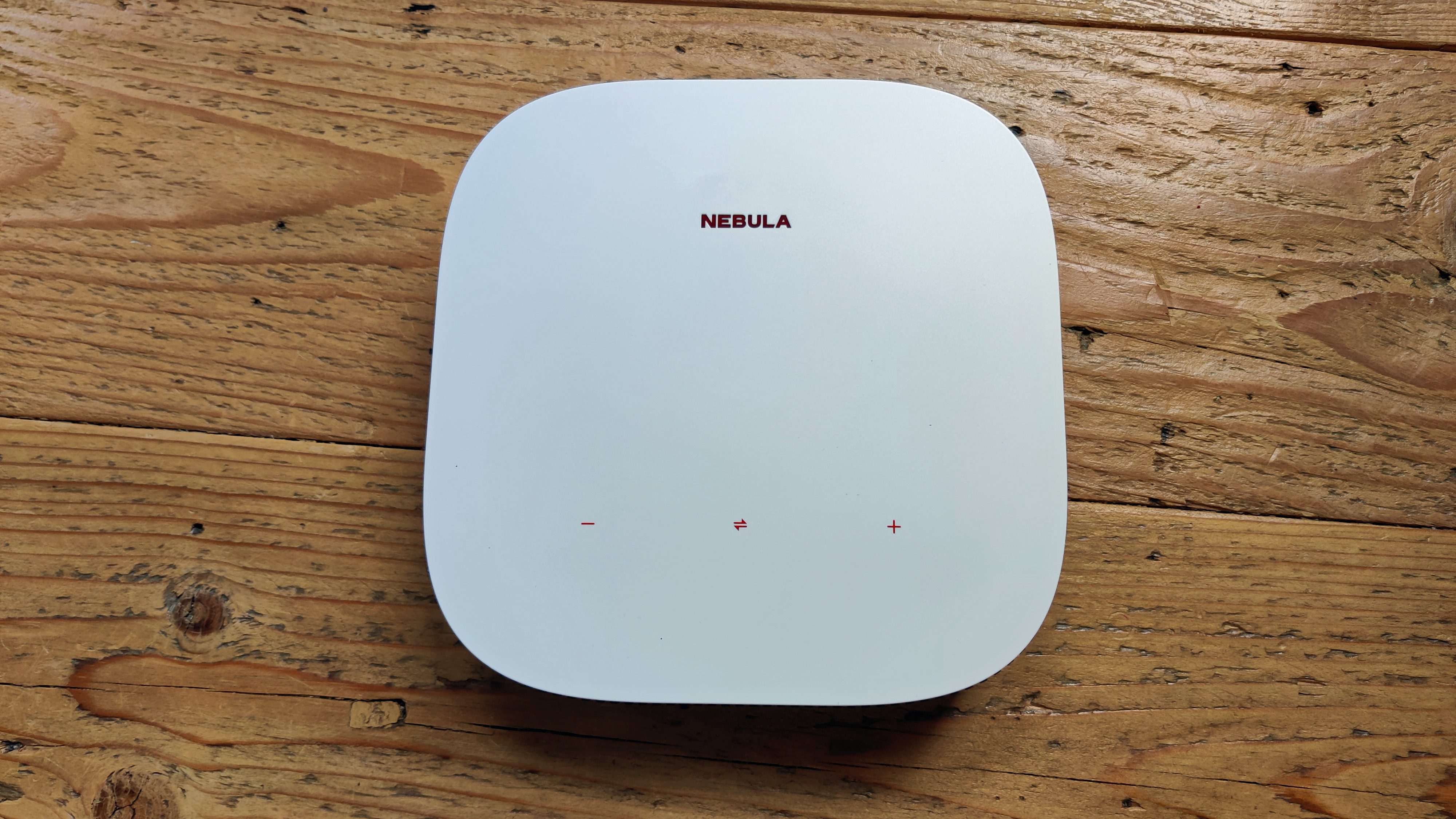Anker Nebula Solar Portable projector against wooden background