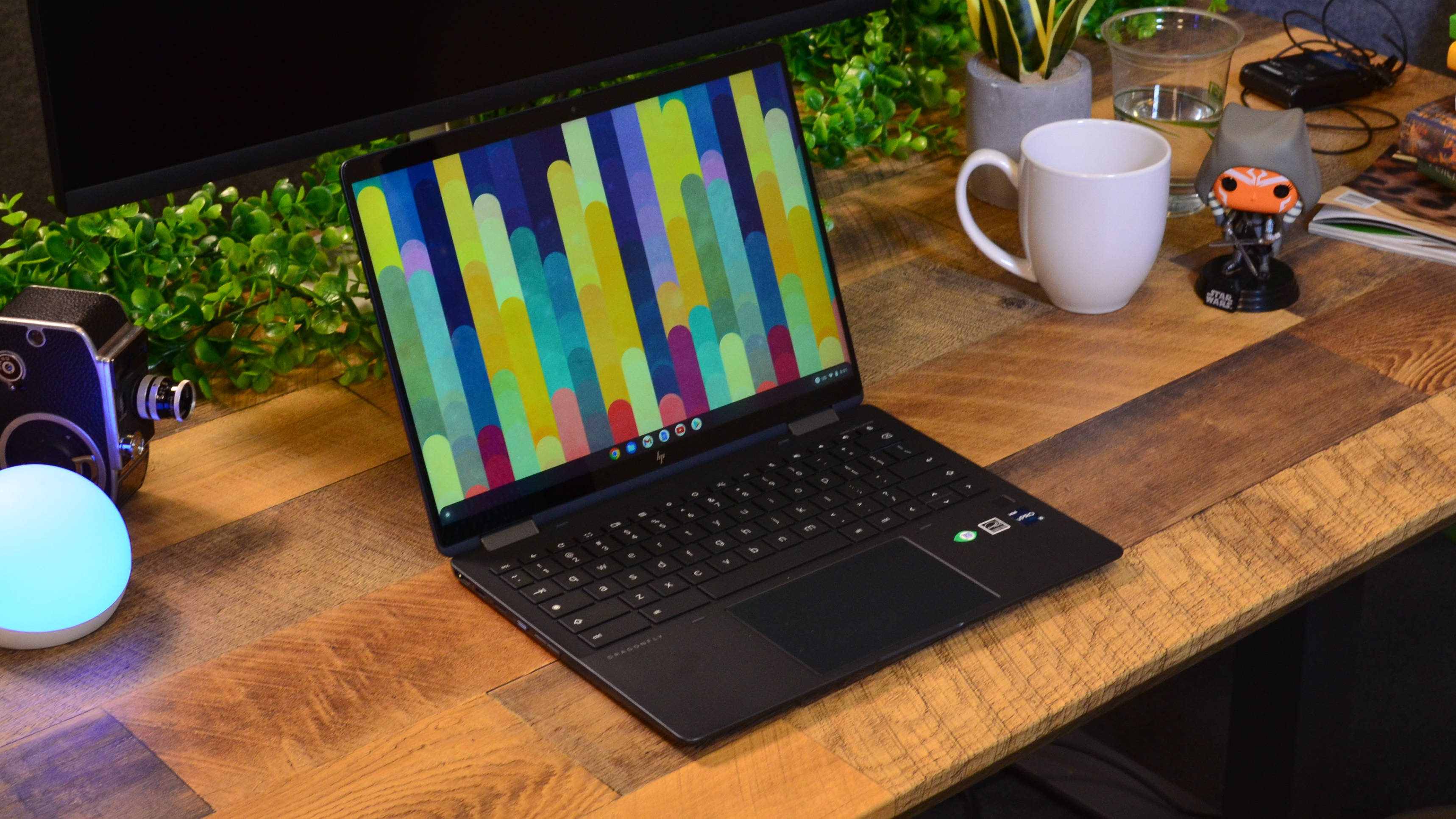 An HP Elite Dragonfly Chromebook on a wooden desk